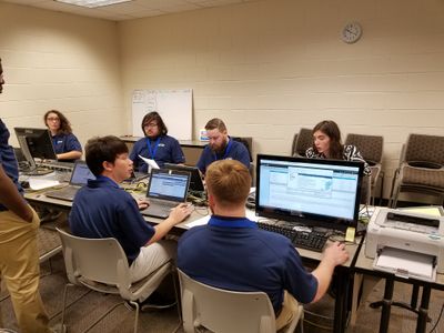 A group of individuals sitting in front of computers at the 2018 South East Regional CCDC.